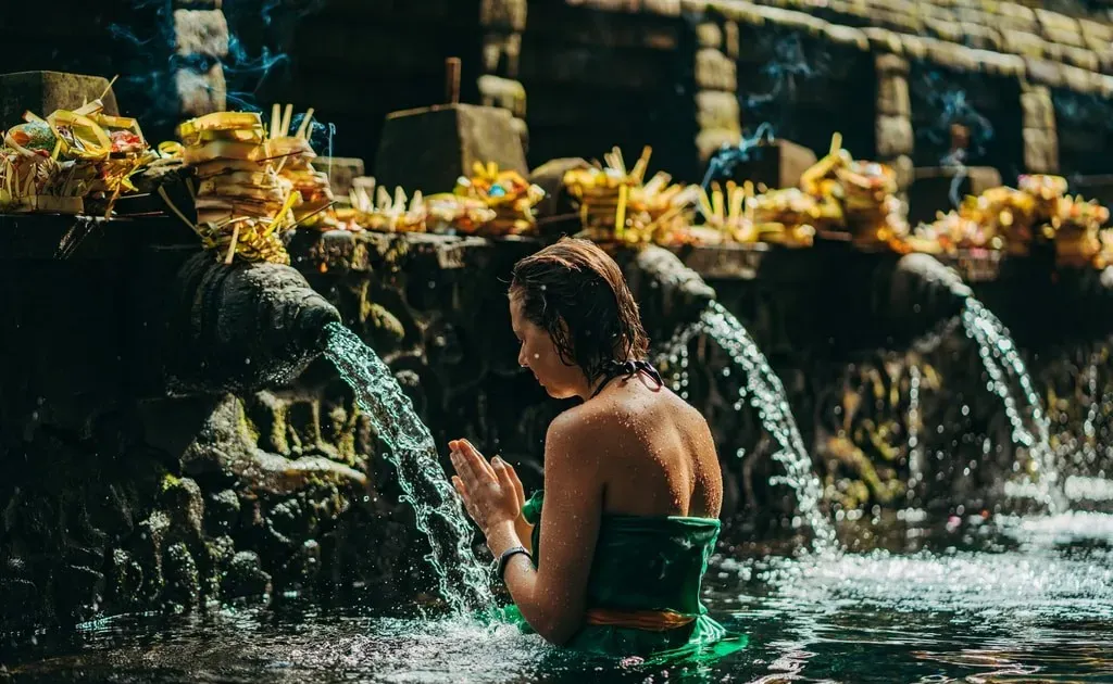 Lidé se účastní očistného rituálu Melukat v chrámu Tirta Empul